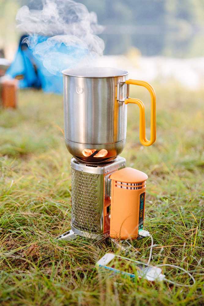 Kettle Pot ovanpå Campt Stove 2 från Biolite, ståendes i gräset med ånga från kokning.