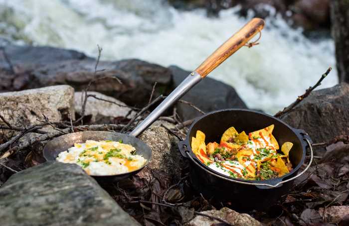 Chilaquiles i dutch oven och  stekta ägg i en kolbullepanna.