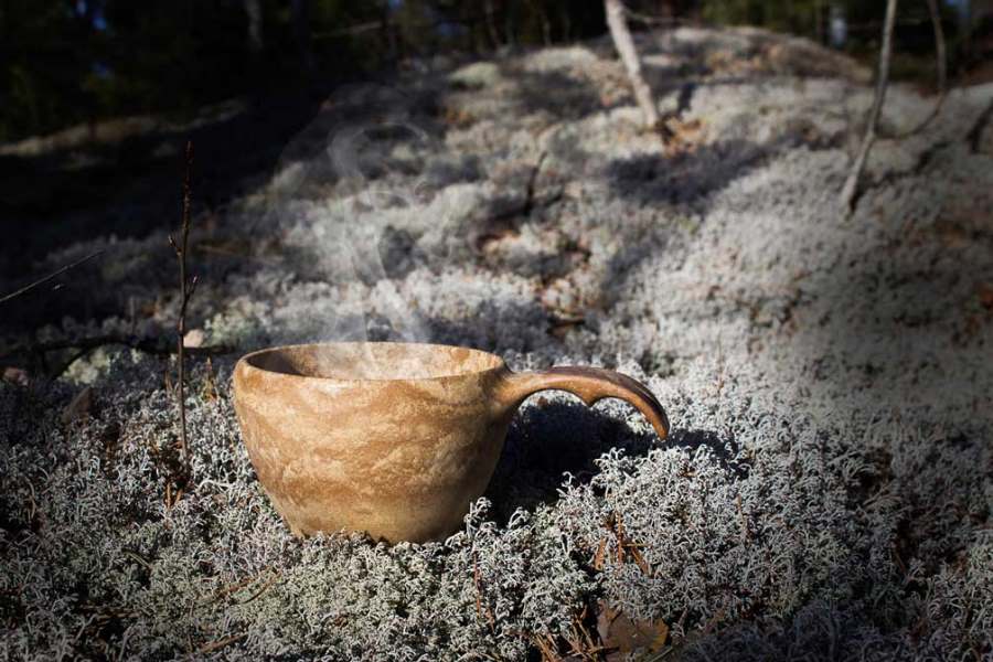 Kupilka 37, kåsa som står på grå lav utomhus.